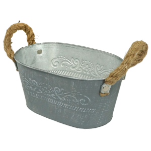 Metalowa osłonka 18 cm w ujęciu pod kątem. Widoczny owalny kształt, postarzana powierzchnia w kolorze szarym oraz dekoracyjne zdobienia roślinne.