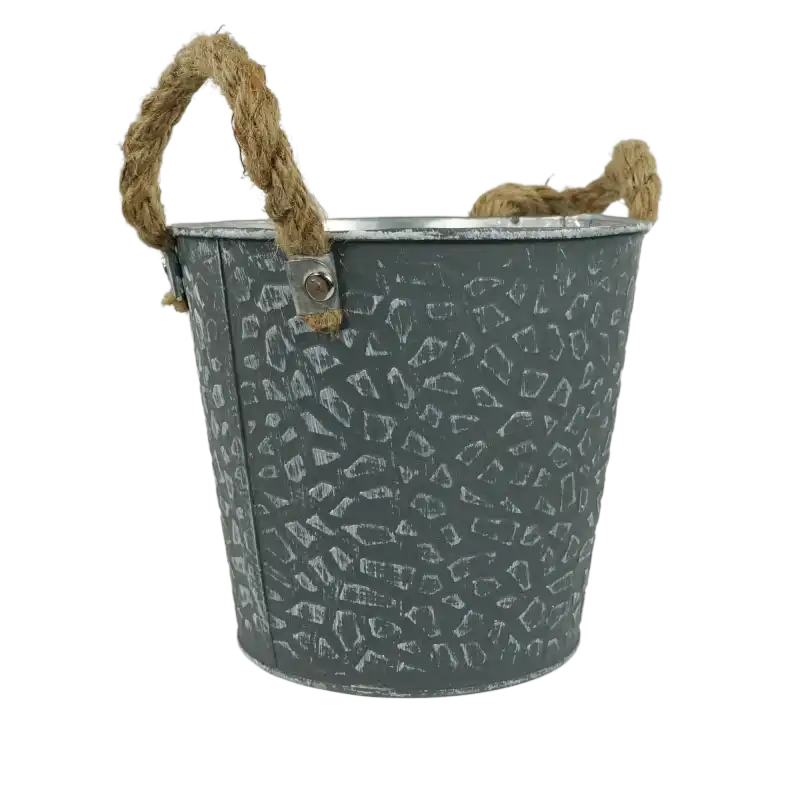 Szara metalowa osłonka na kwiaty o średnicy 16 cm w postarzanym stylu. Okrągła doniczka posiada ozdobne uchwyty z jutowego sznura, które ułatwiają przenoszenie roślin.