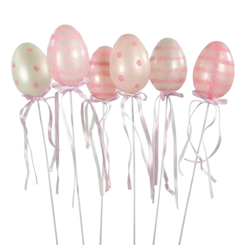 Komplet 6 plastikowych pisanek wielkanocnych o wysokości 6 cm na białym druciku. Jaja w kolorach różu i bieli ozdobione brokatowymi wzorami oraz wstążeczkami. Eleganckie ozdoby na piku do świątecznych kompozycji kwiatowych.