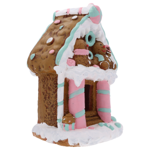 Świąteczny domek z piernika z ceramicznymi detalami w pastelowych kolorach, prezentowany w ujęciu półprofilowym.