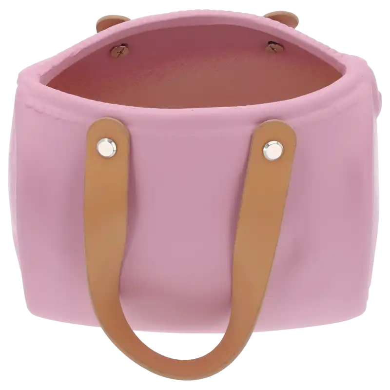 Ceramiczna osłonka na kwiaty w formie torebki z jasnymi uchwytami. Ujęcie z ukosa pokazujące wnętrze naczynia.