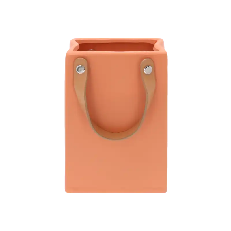 Pomarańczowa gipsowa osłonka w kształcie torebki z uchwytami z ekoskóry. Elegancka ceramiczna dekoracja do wnętrz.