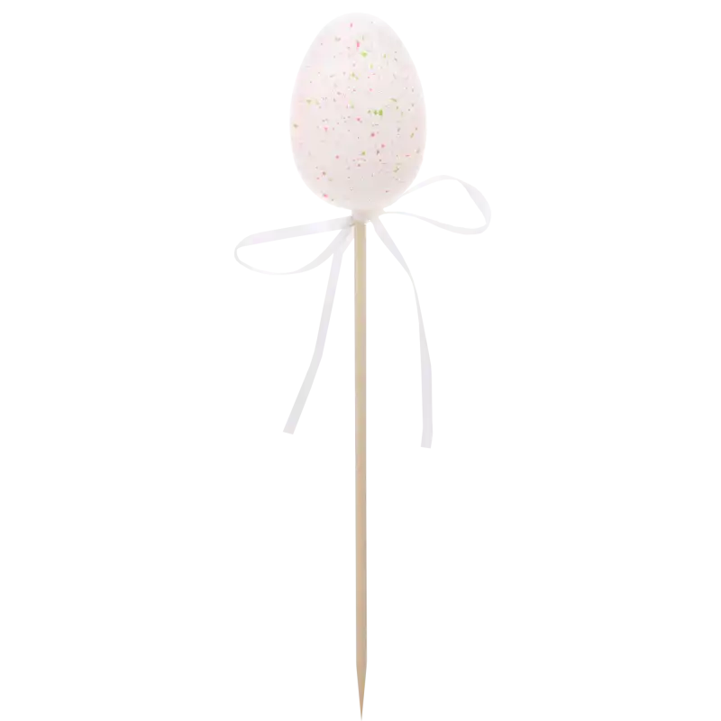 Pojedyncza biała pisanka na piku o wysokości 6 cm, z nakrapianym wzorem i białą wstążką, idealna do wielkanocnych stroików.