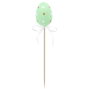 Pojedyncza zielona pisanka na piku o wysokości 6 cm. Jajko w białe i złote kropki z ozdobną kokardką, stanowiące radosny element wielkanocnej aranżacji.