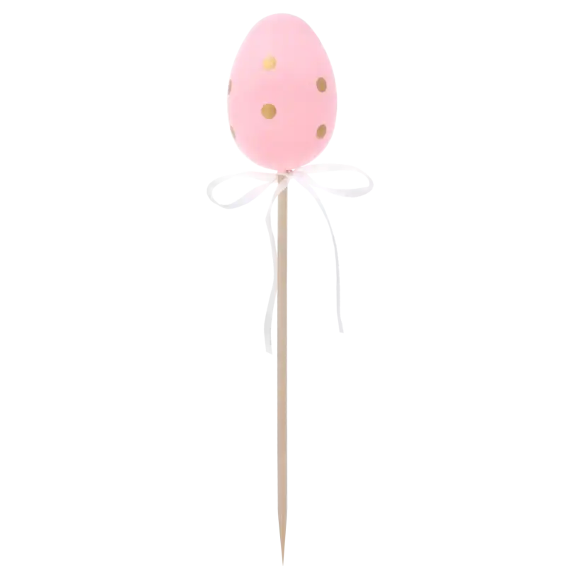 Różowa pisanka na piku z kropkami i białą kokardą. Pastelowa dekoracja wielkanocna na drewnianym patyczku, idealna do wiosennych stroików kwiatowych.