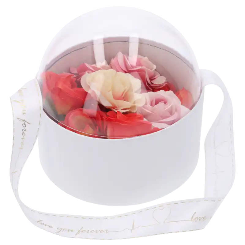 Transparentny flower box wypełniony kolorowymi różami, stanowiący elegancki pomysł na prezent na Komunię.