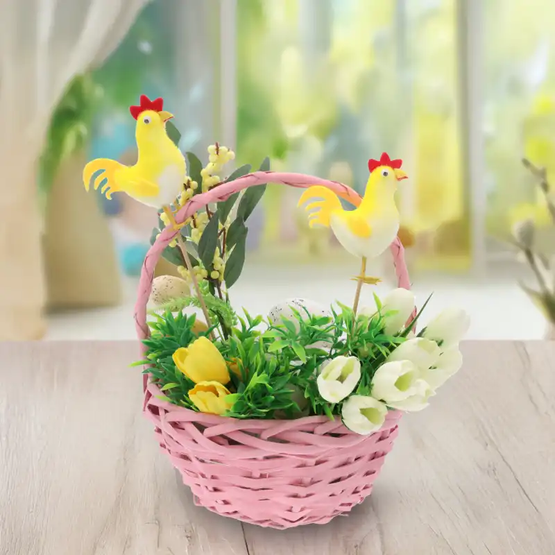 Aranżacja wielkanocna w koszyku z flokowanymi kurami na piku, umieszczona na jasnym blacie w jasnym pomieszczeniu.