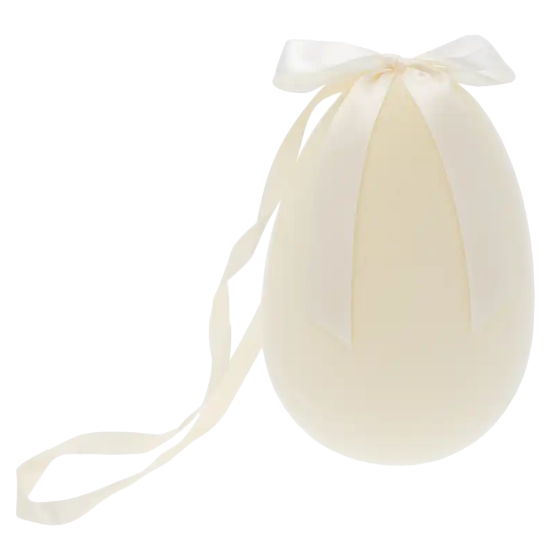 Welurowe jajo zawieszka w rozmiarze 12x8 cm, pokryte miękkim materiałem w jasnym odcieniu, zwieńczone satynową kokardą.