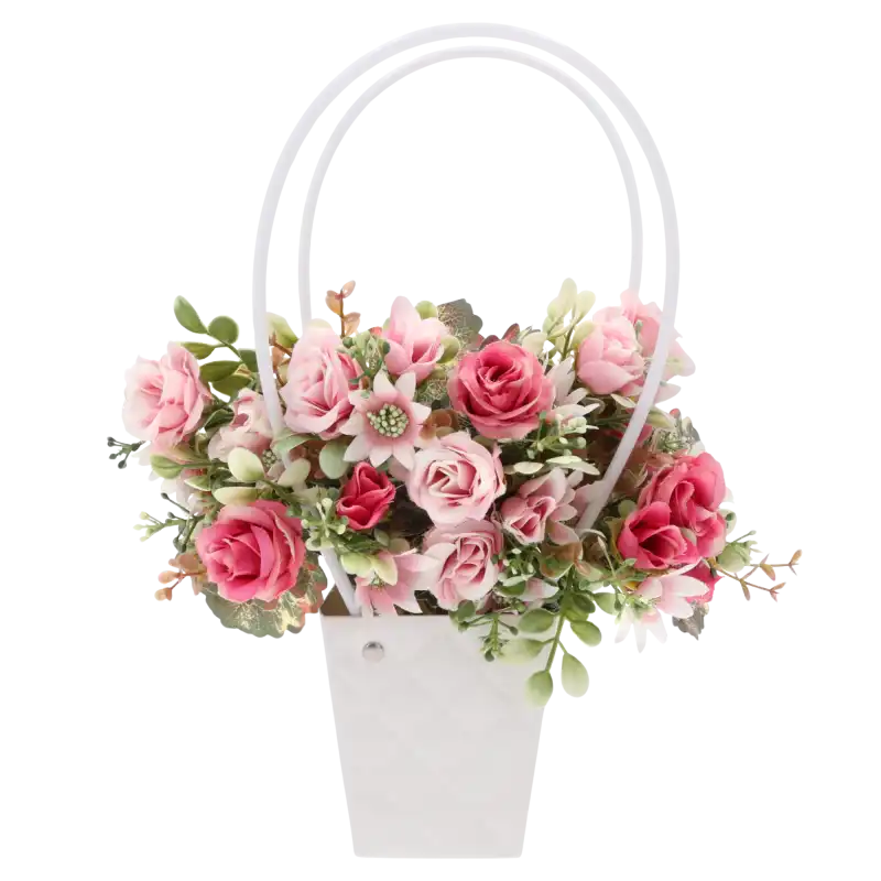 Biała torebka kwiatowa wypełniona różowymi kwiatami. Produkt o wysokości 32 cm stanowi elegancką propozycję na podziękowanie dla rodziców w formie kompozycji.