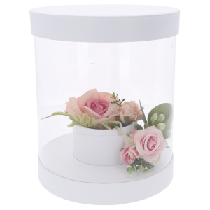 Biały flower box 22 cm z przezroczystymi ściankami i przykładową kompozycją kwiatową wewnątrz. Składane pudełko o wysokości 26 cm do samodzielnego przygotowania bukietów na różne okazje.