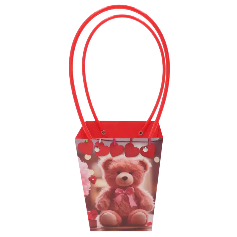 Papierowa torebka kwiatowa z nadrukiem misia o wymiarach 34x15x12 cm, wyposażona w czerwone uchwyty, przeznaczona na bukiety i rośliny doniczkowe.