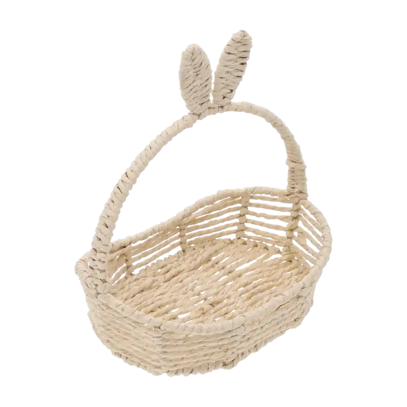 Widok z góry na owalny beżowy koszyk z króliczymi uszami. Pleciona konstrukcja o wymiarach wewnętrznych 21x13 cm zapewnia stabilność podczas świątecznych aranżacji.