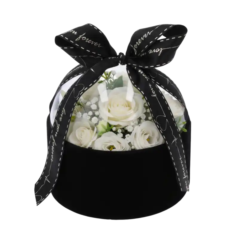 Czarny welurowy flower box 13 cm z wypełnieniem z białych róż, prezentujący sposób ekspozycji kwiatów pod przezroczystą pokrywką.