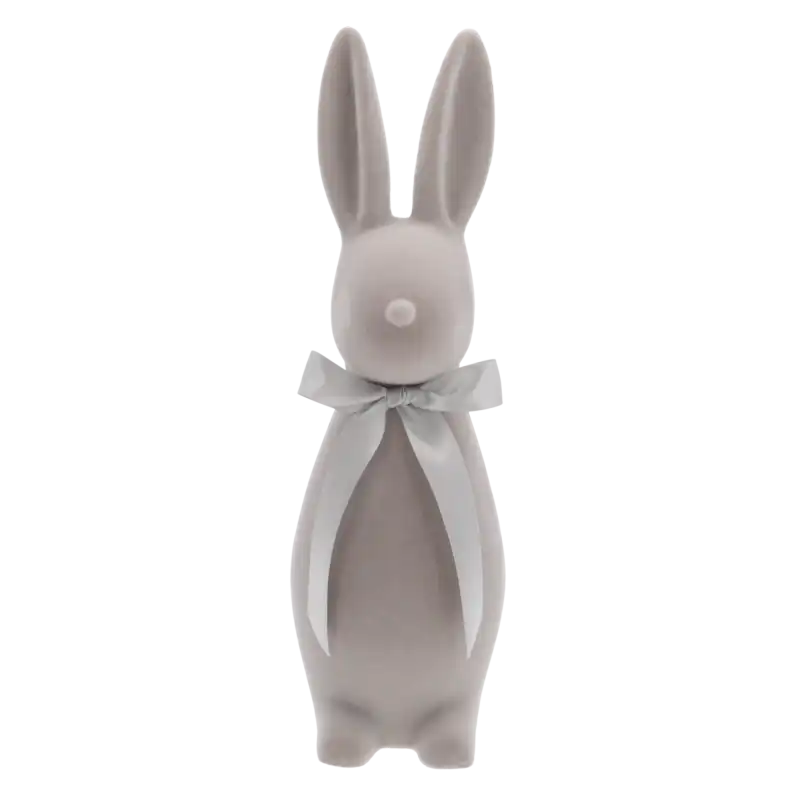 Szary welurowy zając 47 cm to elegancka dekoracja wielkanocna o nowoczesnej formie, wykończona satynową kokardą, idealna do wiosennych aranżacji wnętrz.