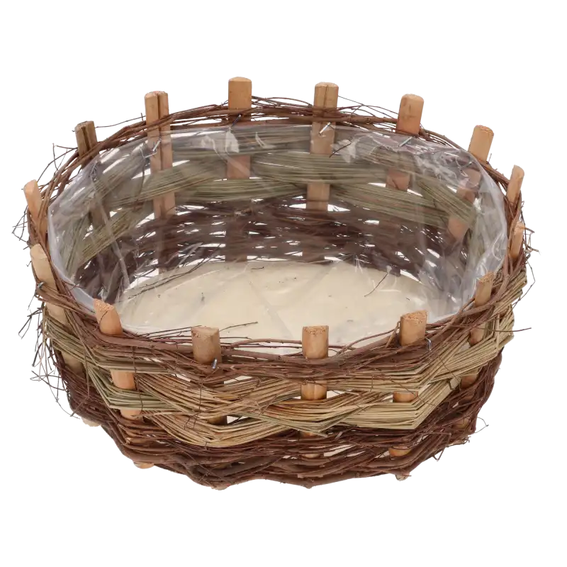 Zbliżenie na wnętrze owalnej osłonki z kory, w której widoczna jest przezroczysta folia ochronna.