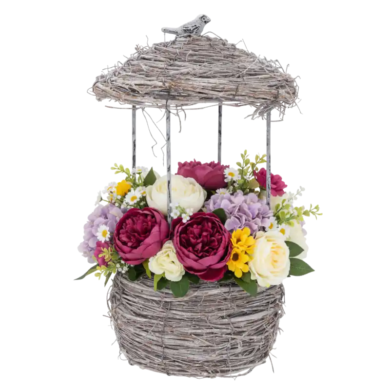 Osłonka w kształcie karmnika wypełniona kolorową kompozycją kwiatową z piwoniami i hortensjami, pokazująca funkcjonalność jako doniczka ogrodowa.