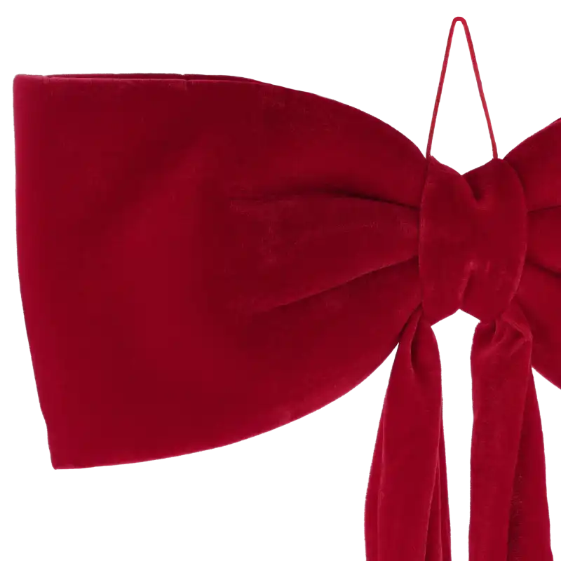 Zbliżenie na węzeł i eleganckie wykończenie czerwonej kokardy wykonanej z wysokiej jakości miękkiego w dotyku weluru.