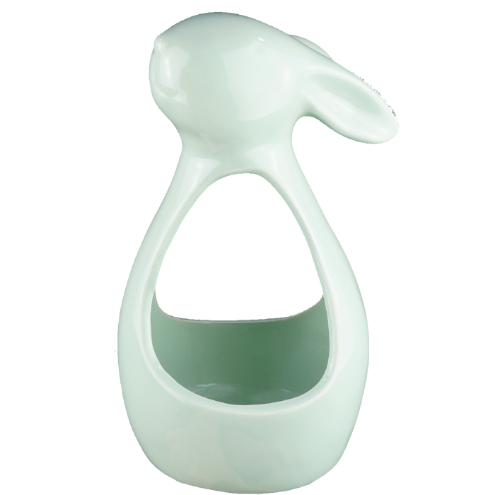 Ceramiczny świecznik w kształcie królika w kolorze zielonym. Otwarta konstrukcja umożliwia umieszczenie wewnątrz świecy, tworząc nastrojowe oświetlenie w pomieszczeniu.